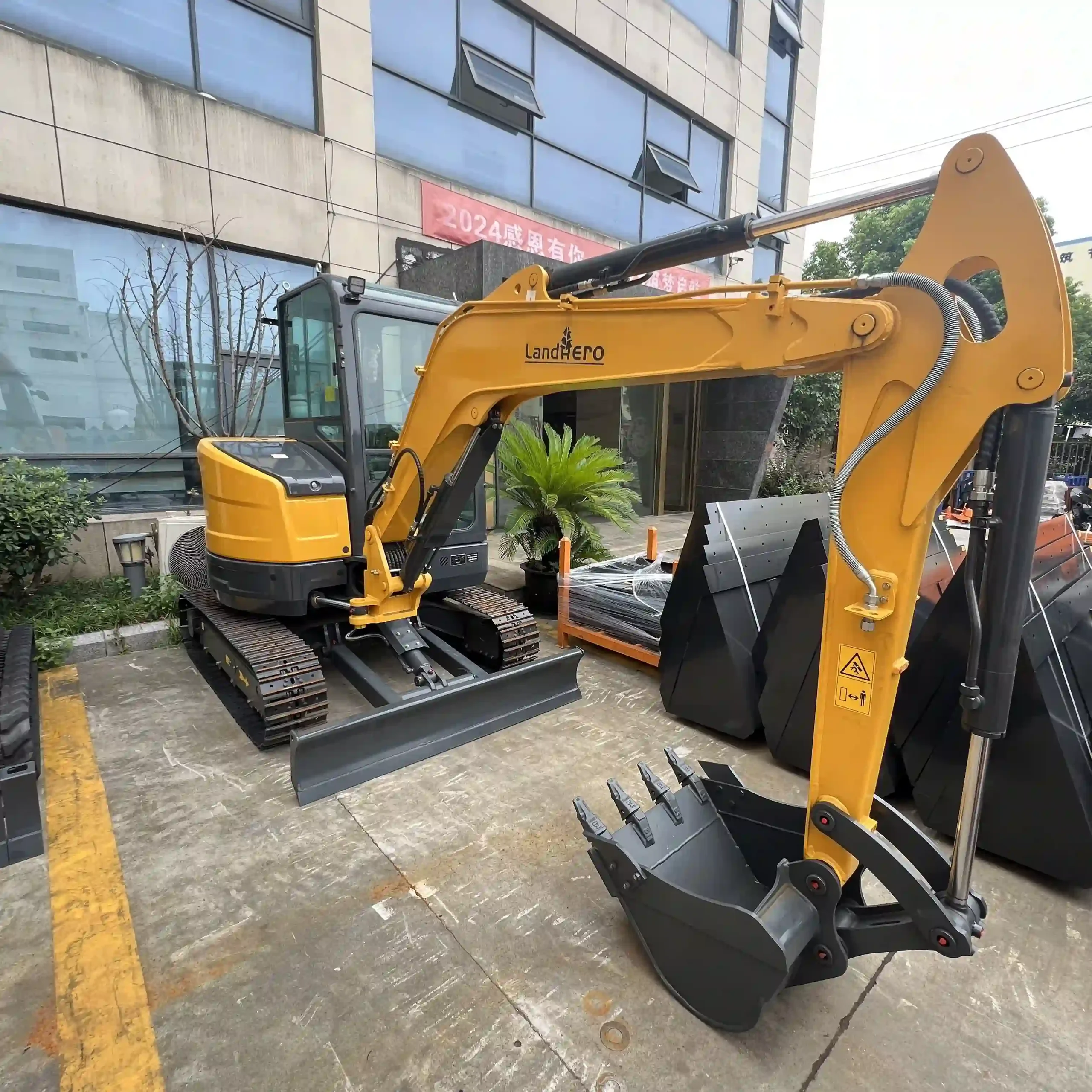 a yellow landhero construction vehicle with a bucket